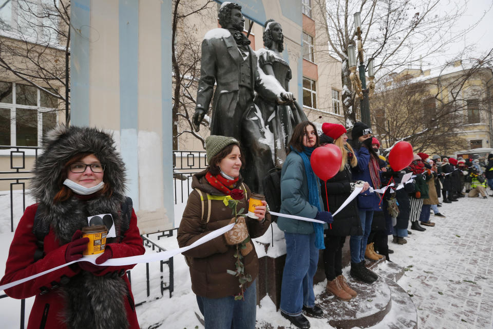 Women, some of them wearing face masks to protect against coronavirus, attend a rally in support of jailed opposition leader Alexei Navalny and his wife Yulia Navalnaya, in Moscow, Russia, Sunday, Feb. 14, 2021. (AP Photo/Alexander Zemlianichenko)