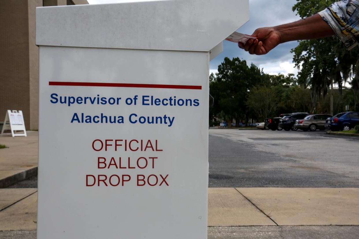 A person drops off their early voting ballot at the Alachua County Supervisor of Elections Office in Gainesville on Aug. 8, 2020. [File]