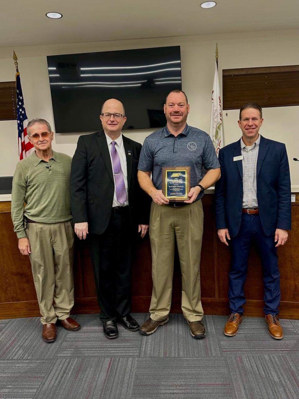 Matt Peoples is presented with the OAPWA 2022 Clyde “Butch” Seidle Public Works Servant Leader Award.  From right to left: Mayor Mike Ebert; Larry Lester, Past President of the OAPWA; Matt Peoples, Canal Winchester Director of Public Service; Glenn Marzluf, OAPWA member.