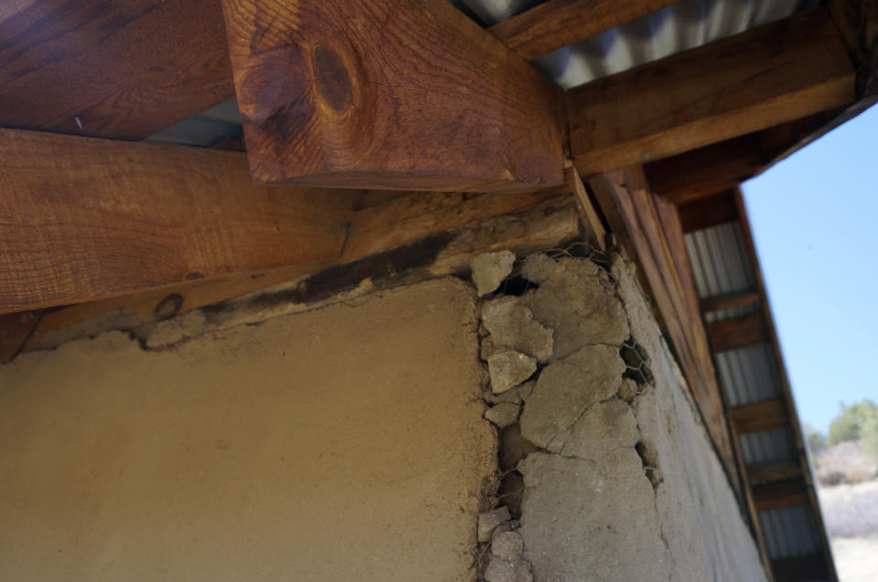 Cracks appear where the preserved adobe wall abuts a cement addition on the 1860s San Isidro chapel near the hamlet of Holman, New Mexico, Saturday, April 15, 2023. The chapel or "morada" is used for prayer, study and hosting pilgrims by a local Catholic brotherhood that has long played a crucial role in preserving the faith in these remote mountain valleys. (AP Photo/Giovanna Dell'Orto)