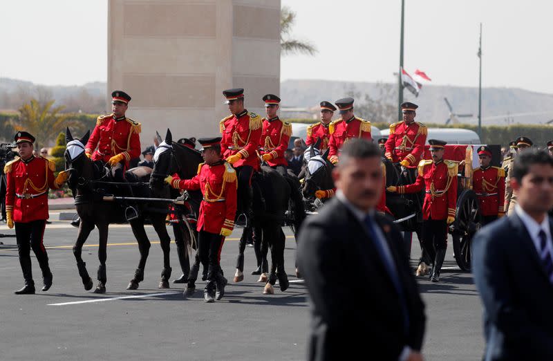 The coffin of former Egyptian President Hosni Mubarak is carried on a horse-drawn hearse during his funeral, east of Cairo