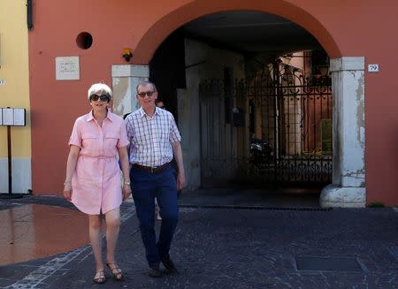 Britain's Prime Minister Theresa May walks with her husband Philip in Desenzano del Garda, by Lake Garda, northern Italy, July 25, 2017. REUTERS/Antonio Calanni/Pool