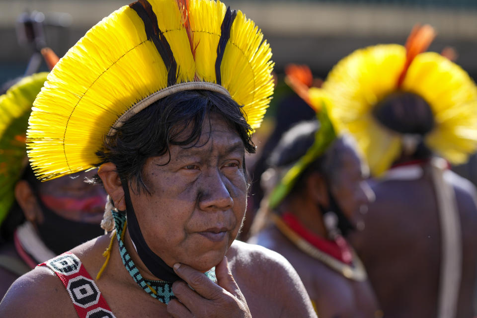 An Indigenous leader protests outside Congress in Brasilia, Brazil, Wednesday, June 23, 2021. Indigenous activists have traveled to the capital to demand government action to halt illegal mining and logging on their reservations and oppose a proposed bill they say would limit recognition of tribal lands. (AP Photo/Ricardo Mazalan)