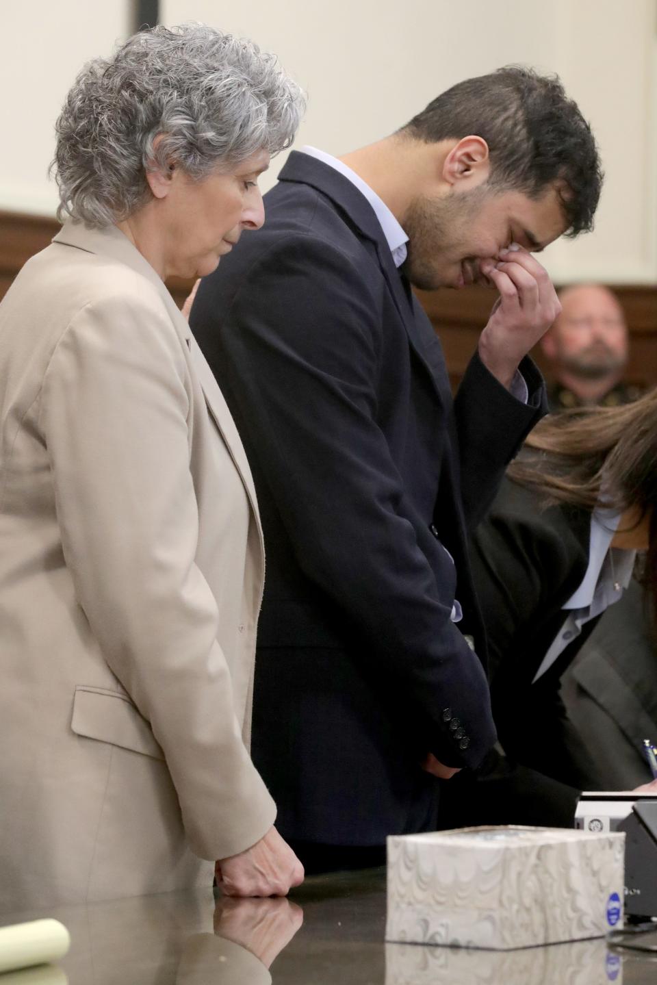 Mohamed Reeda is comforted by defense attorney Diane Guzzo as a jury returns a split verdict Monday in his rape and kidnapping trial in Summit County Common Pleas Court.