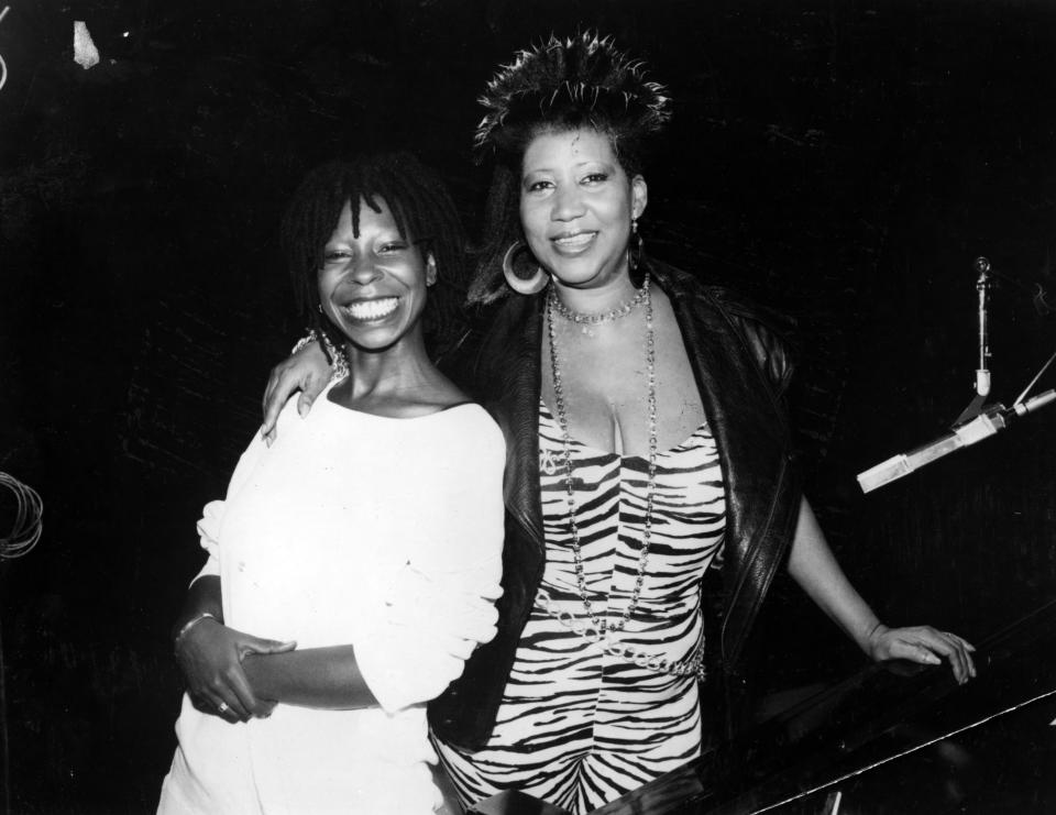 <p>Aretha Franklin wears a leaopard print mini dress, leather shawl jacket, and gold hoop earrings while posing with comedian and actress Whoopi Goldberg. (Photo by Afro American Newspapers/Gado/Getty Images) </p>