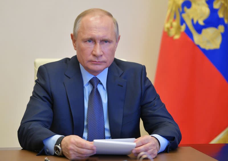 Russian President Putin chairs a meeting via a video link outside Moscow