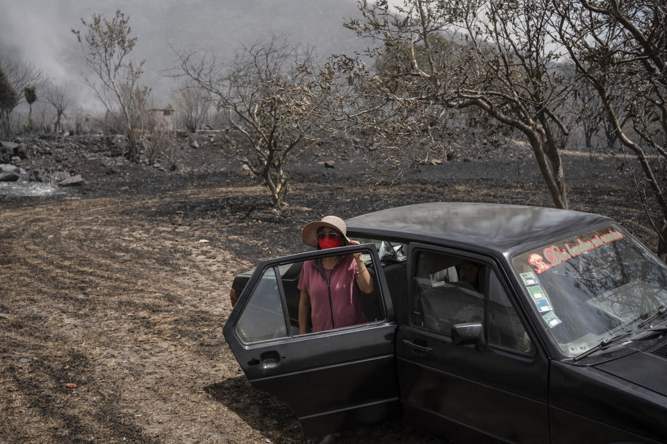 Catalina Villafuerte watches her farm burned by wildfires in Maltrata, in the High Mountains area of Veracruz state, Mexico, Monday, March 25, 2024. (AP Photo/Felix Marquez)