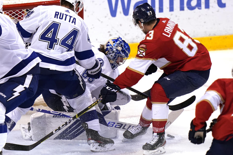 Tampa Bay Lightning goaltender Andrei Vasilevskiy, center, defends the goal during the third period of an NHL hockey game against the Florida Panthers, Monday, May 10, 2021, in Sunrise, Fla. At right is Florida Panthers right wing Juho Lammikko (83). (AP Photo/Lynne Sladky)