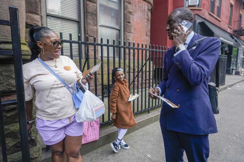 New York City Council candidate Yusef Salaam, right, talks to a Harlem resident while canvasing in the neighborhood, Wednesday, May 24, 2023, in New York. Salaam is one of three candidates in a competitive June 27 Democratic primary. With early voting already begun, he faces two seasoned political veterans: New York Assembly members Al Taylor, 65, and Inez Dickens, 73, who previously represented Harlem on the City Council. (AP Photo/Mary Altaffer)