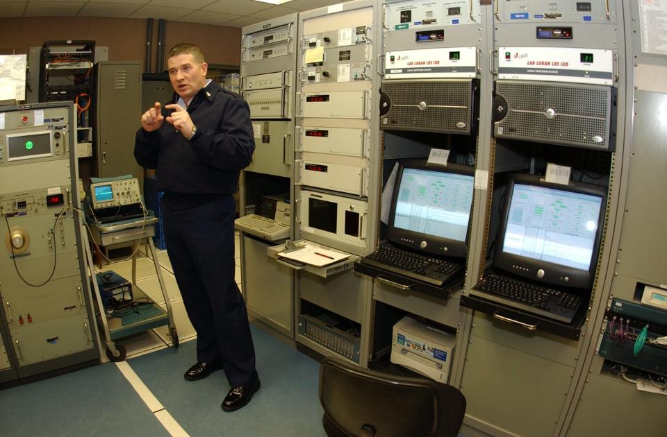 In this 2004 photo, Chief Petty Officer Ray Beavers explains how the Coast Guard's LORAN station near Carolina Beach operates as an aid to navigation for ships, boats and aircraft. The station broadcasts a 600,000 watt signal from an antenna array of four 625-foot towers that, when used in conjunction with other LORAN stations, helps vessels locate themselves using the broadcasts.