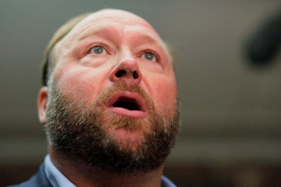 Radio host Alex Jones of Infowars talks to the news media as he arrives to listen to the testimony of Twitter CEO Jack Dorsey and Facebook COO Sheryl Sandberg at a Senate Intelligence Committee hearing on foreign influence operations on social media platforms on Capitol Hill in Washington, U.S., September 5, 2018. REUTERS/Jim Bourg