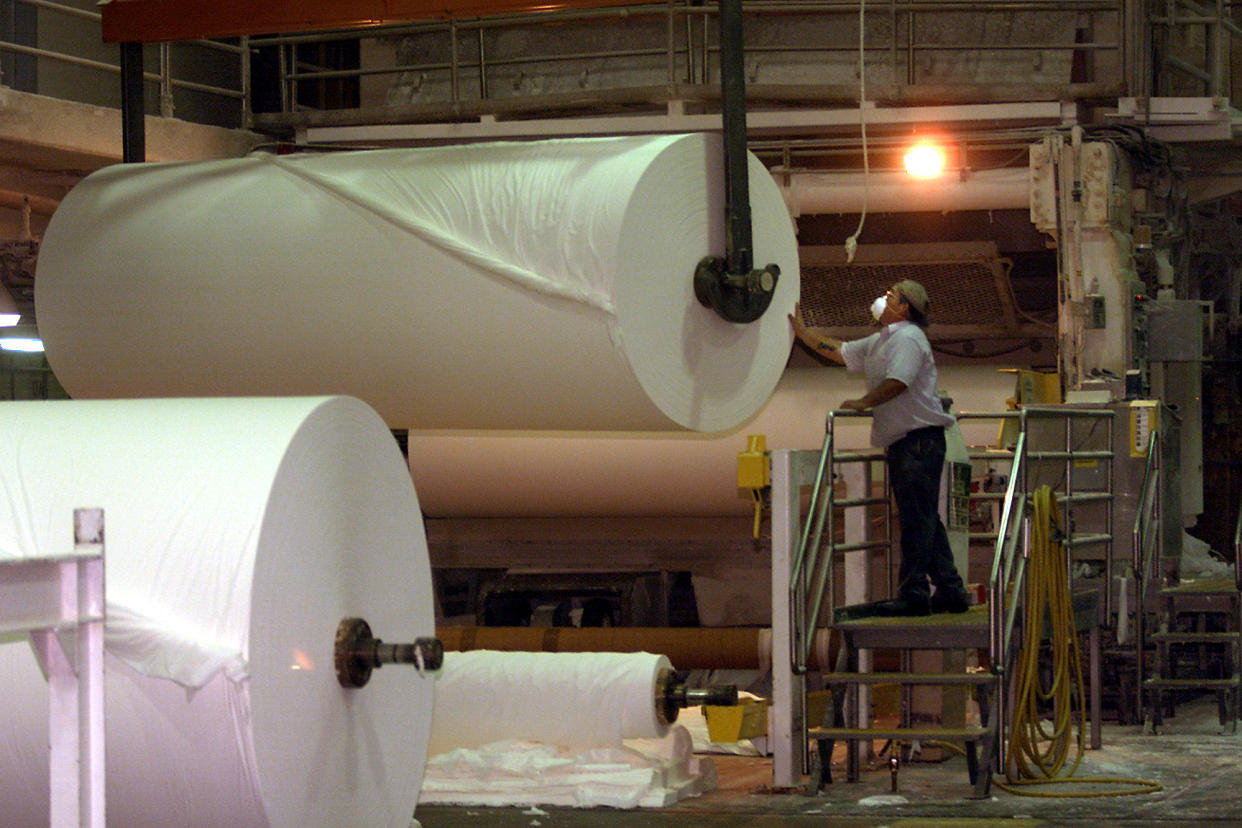 Kimberly–Clark's Fullerton mill, which produces tissue and toilet paper and paper towels, adapted to the half–hour notices it was given under a voluntary cutback program. But it worries about the safety of its workers and high–speed production equipment if it gets only 10–minute notice of rotating outages. An employee works with 4–ton rolls of tissue coming out of the tissue machine Wednesday.  (Photo by Al Schaben/Los Angeles Times via Getty Images)