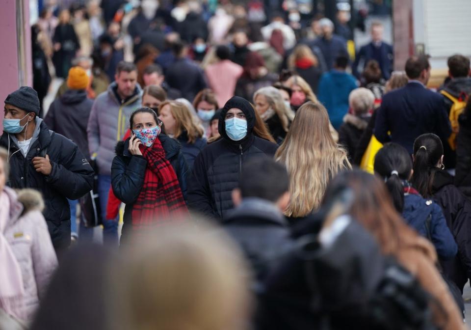 People wearing face masks walking along Oxford Street, London (PA Wire)