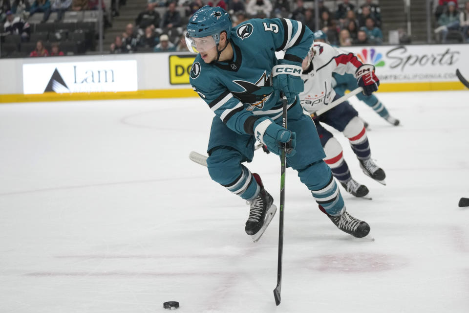 San Jose Sharks defenseman Matt Benning (5) skates with the puck against the Washington Capitals during the second period of an NHL hockey game in San Jose, Calif., Monday, Nov. 27, 2023. (AP Photo/Jeff Chiu)