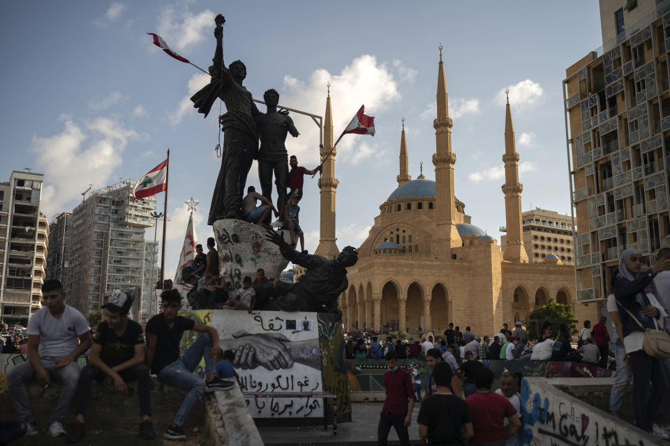 People gather at the Martyrs Square during a protest against the political elite and the government following last Tuesday's deadly explosion at the Beirut port which devastated large parts of the capital, in Beirut, Lebanon, Sunday, Aug. 9, 2020. (AP Photo/Felipe Dana)