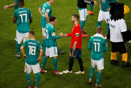 Soccer Football - International Friendly - Germany vs Spain - ESPRIT arena, Dusseldorf, Germany - March 23, 2018 Germany’s Mesut Ozil shakes hands with Spain’s Sergio Ramos after the match REUTERS/Wolfgang Rattay