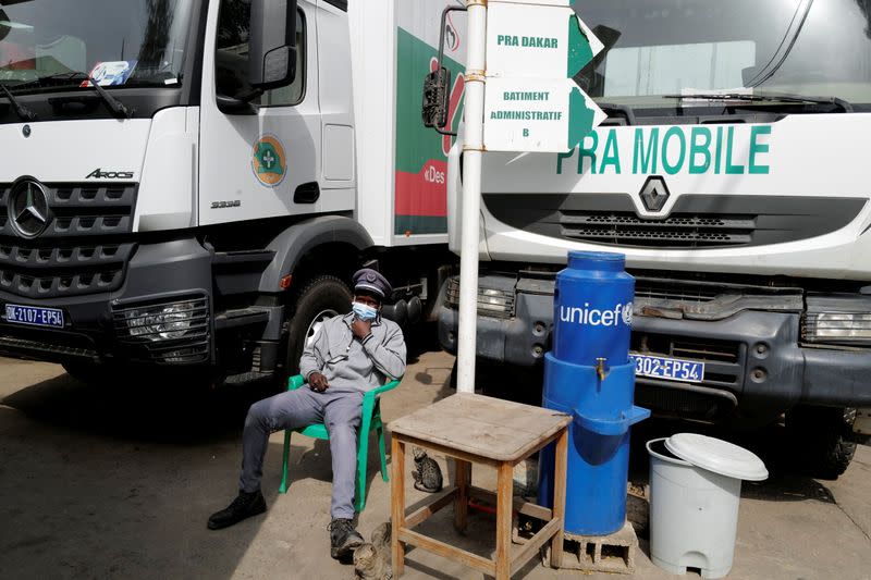 A security guard wears a face mask at the entrance of National Supply Pharmacy center in Dakar