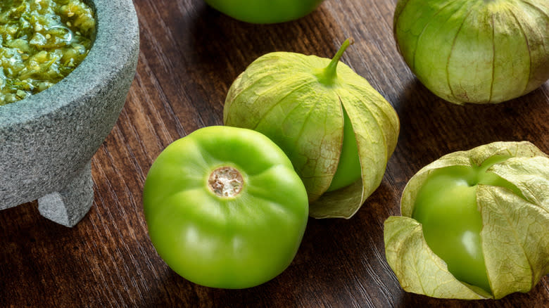 fresh tomatillos with husks peeling