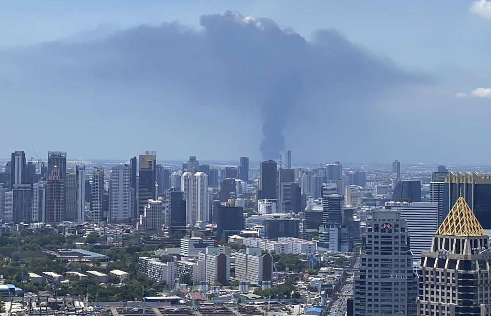 In a view from downtown Bangkok, giant plumes of smoke can be seen rising from the Samut Prakan province, Thailand, Monday, July 5, 2021. A massive explosion at a factory on the outskirts of Bangkok has shaken an airport terminal serving Thailand’s capital, damaged homes in the surrounding neighborhood, and prompted the evacuation of a wide area over fears of poisonous fumes from burning chemicals and the possibility of additional denotations. (Tina Liu via AP)