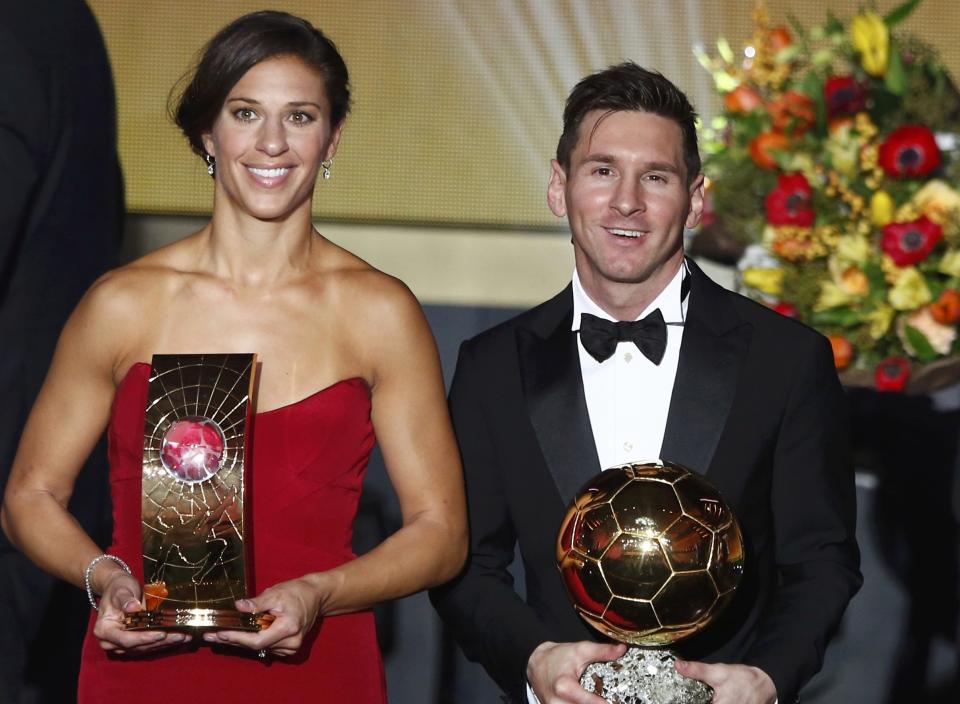 Messi of Argentina poses with Lloyd of the US with their World Player of the Year awards during the FIFA Ballon d'Or 2015 ceremony in Zurich