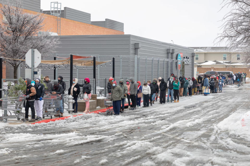 People wait outside a supermarket in freezing temperatures in Texas.