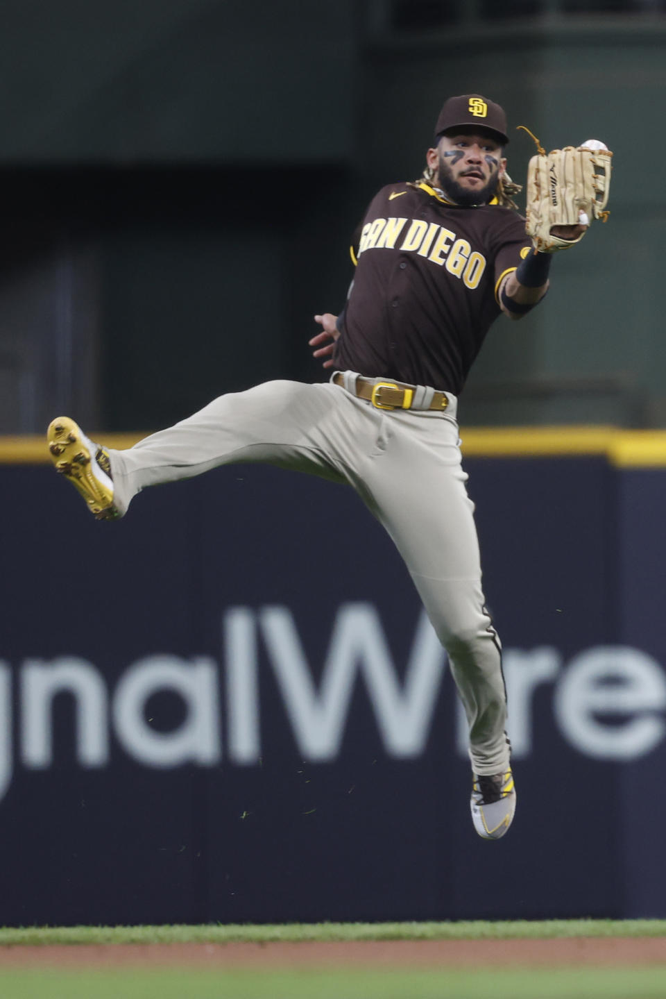 San Diego Padres shortstop Fernando Tatis Jr. makes a leaping catch on a ball hit by Milwaukee Brewers' Daniel Robertson during the second inning of a baseball game Thursday, May 27, 2021, in Milwaukee. (AP Photo/Jeffrey Phelps)