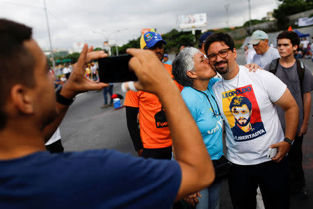 Freddy Guevara (R), first Vice-President of the National Assembly and lawmaker of the Venezuelan coalition of opposition parties, poses for a picture with supporters during a protest against Venezuelan President Nicolas Maduro's government in Caracas, Venezuela May 15, 2017. REUTERS/Carlos Garcia Rawlins