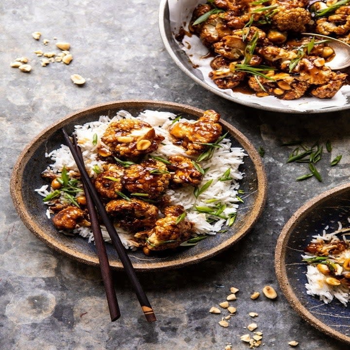 Three bowls of ricer, crispy kung pao cauliflower and herbs