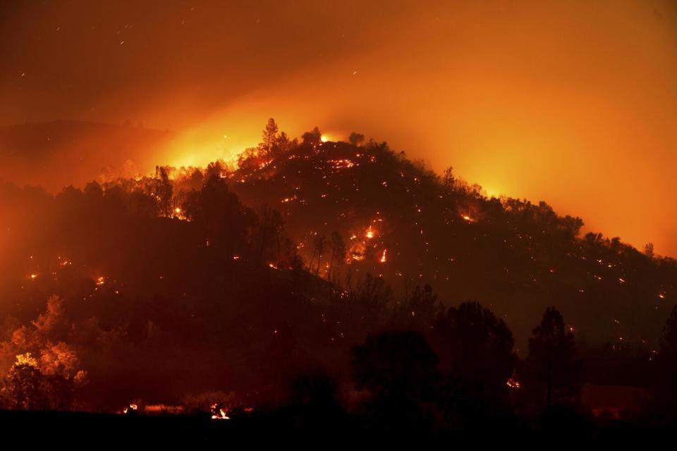 Flames from the French fire burn on a hillside above Mariposa on Friday.