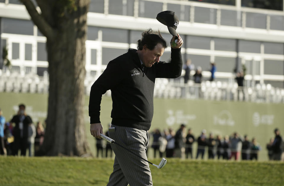 Phil Mickelson tips his hat on the 18th green of the Pebble Beach Golf Links after winning the AT&T Pebble Beach Pro-Am golf tournament Monday, Feb. 11, 2019, in Pebble Beach, Calif. (AP Photo/Eric Risberg)