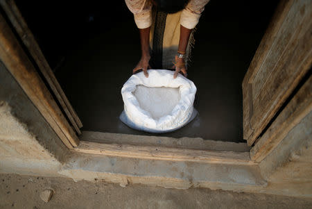 A man displays a sack of wheat flour at his home in the village of al-Jaraib in the northwestern province of Hajjah, Yemen, February 19, 2019. REUTERS/Khaled Abdullah