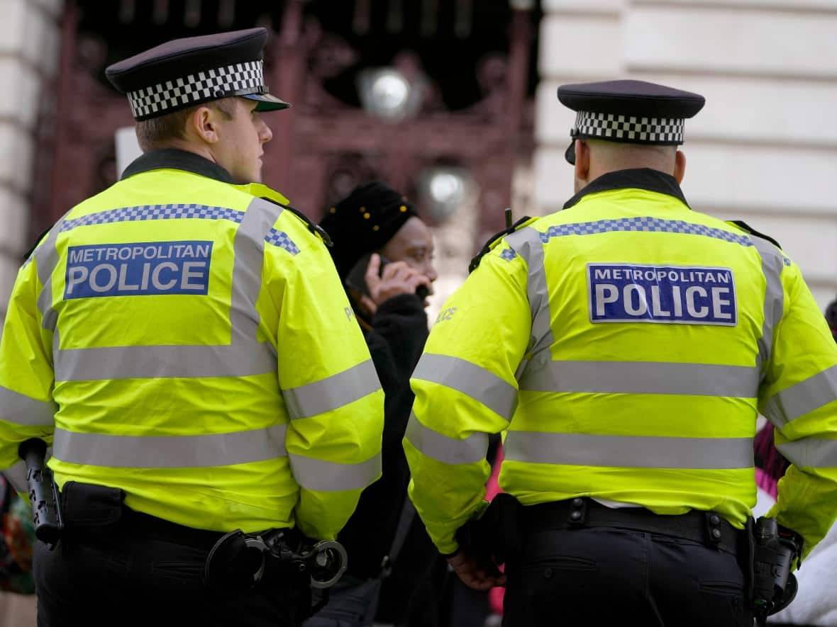 Police officers patrol in London on Oct. 1, 2021. The case of David Carrick, a former Metropolitan Police officer who admitted to being a serial rapist and is set to be sentenced this week has thrown a spotlight on what some say is a culture of misogyny within the force.  (Frank Augstein/The Associated Press - image credit)