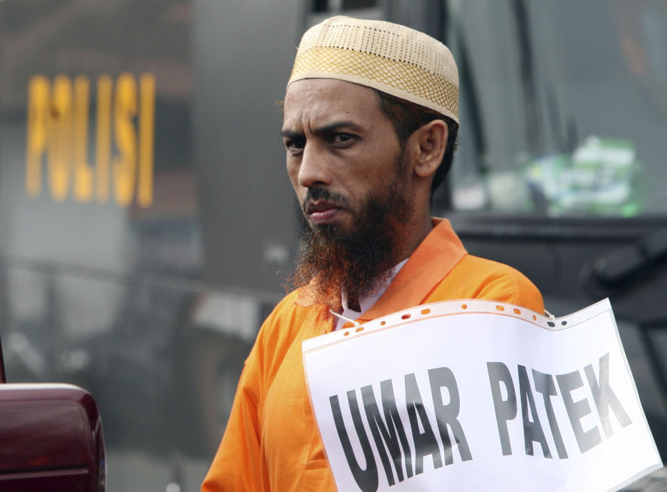 FILE - Convicted Muslim militant Umar Patek Umar Patek pauses during the police reenactment of the scenes leading to the 2002 Bali bombing, in Denpasar, Bali Indonesia, Thursday, Oct. 20, 2011. A bombmaker in the 2002 Bali attack that killed 202 people has walked free from an Indonesian prison Wednesday, Dec. 7, 2022 after serving half of a 20-year sentence, despite upsetting Australia’s leader who described him as “abhorrent.” Umar Patek, 55, whose real name is Hisyam bin Alizein, was a leading member of the al Qaida-linked network Jemaah Islamiyah. (AP Photo/Firdia Lisnawati, File)