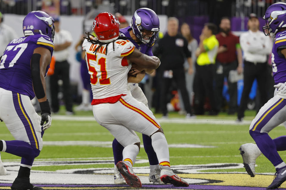 Minnesota Vikings quarterback Kirk Cousins is sacked by Kansas City Chiefs defensive end Mike Danna (51) during the second half of an NFL football game, Sunday, Oct. 8, 2023, in Minneapolis. The Chiefs won 27-20. (AP Photo/Bruce Kluckhohn)