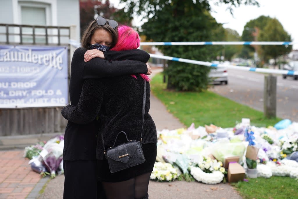 People hug at the scene near Belfairs Methodist Church in Leigh-on-Sea, Essex, where Conservative MP Sir David Amess was killed (Kirsty O’Connor/PA) (PA Wire)