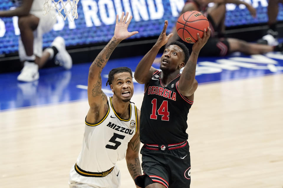 Georgia's Tye Fagan (14) drives against Missouri's Mitchell Smith (5) in the first half of an NCAA college basketball game in the Southeastern Conference Tournament Thursday, March 11, 2021, in Nashville, Tenn. (AP Photo/Mark Humphrey)