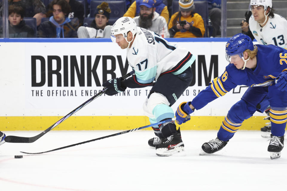 Seattle Kraken center Jaden Schwartz (17) carries the puck past Buffalo Sabres defenseman Rasmus Dahlin (26) during the second period of an NHL hockey game Tuesday, Jan. 9, 2024, in Buffalo, N.Y. (AP Photo/Jeffrey T. Barnes)