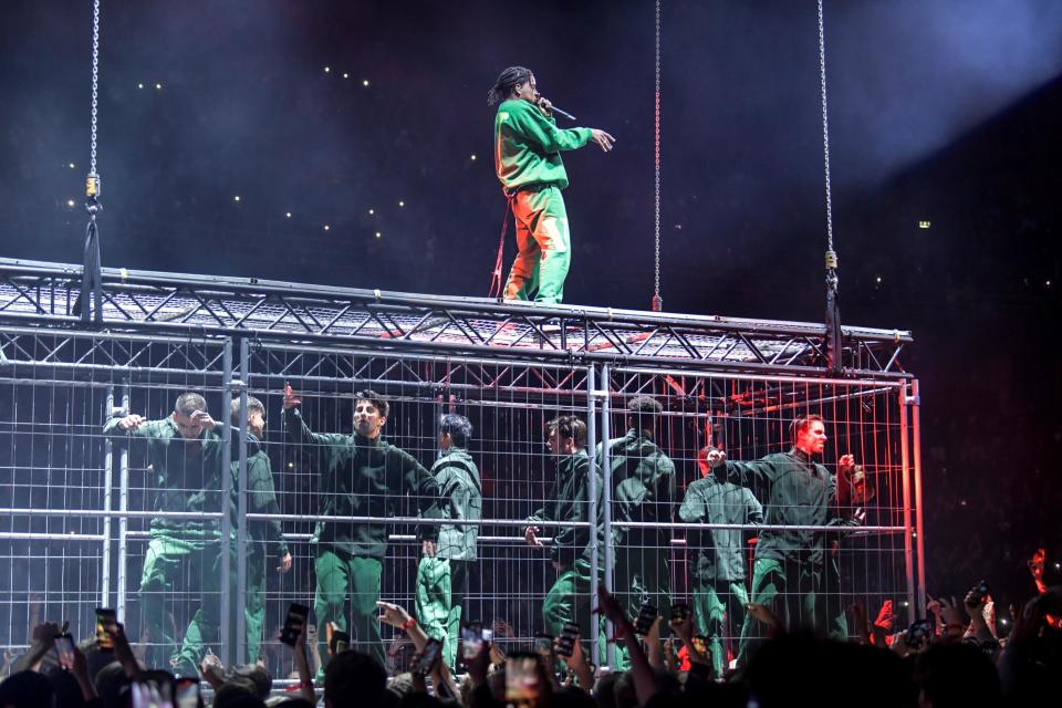 The performance saw the rapper climb onto a cage full of people (Reuters)