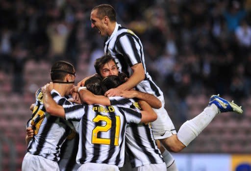 Juventus defender Giorgio Chiellini (top) celebrates with teammates, at the end of their Italian Serie A match against Cagliari at Nereo Rocco stadium in Trieste. Having gone the entire season unbeaten with one match to play, no-one could begrudge Juventus their 28th Italian league title, secured with a 2-0 victory over Cagliari on Sunday