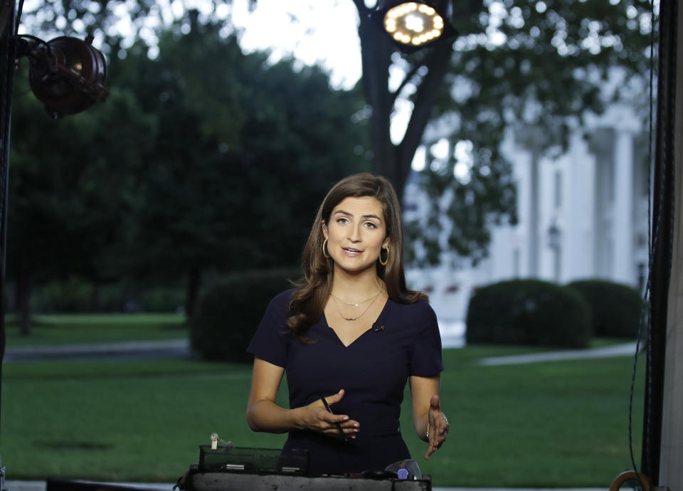 FILE - This July 25, 2018 file photo shows CNN White House correspondent Kaitlan Collins during a live shot in front of the White House in Washington. Reporters Collins, Yamiche Alcindor and Weijia Jiang have faced hostility from President Donald Trump at news conferences with stoicism. Their experiences illustrate the challenge of working at a White House with near-daily accessibility to a president who considers the press an enemy. (AP Photo/Alex Brandon, File)