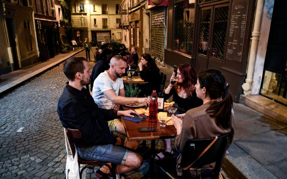 Diners gather at a cafe in Montmarte in anticipation of the formal reopening of French cafes on June 2 - ALAIN JOCARD/AFP