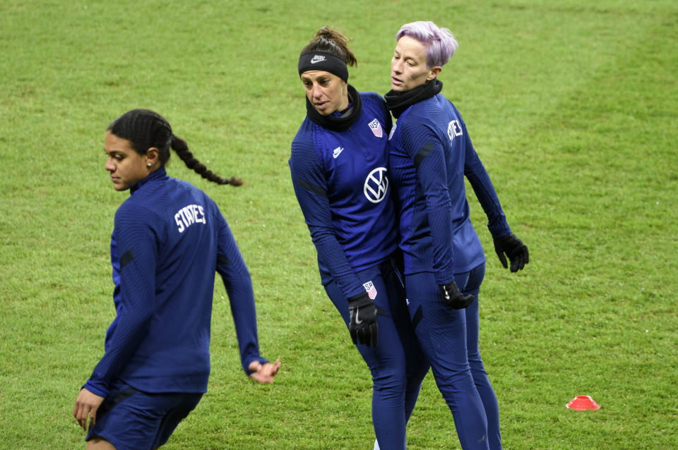 Alana Cook, left, Carli Lloyd and Megan Megan Rapinoe, right, attend a training session at Friends arena in Stockholm, Sweden, Friday April 9, 2021, ahead of the friendly international soccer match against Sweden on Saturday. (Henrik Montgomery/TT News Agency via AP)