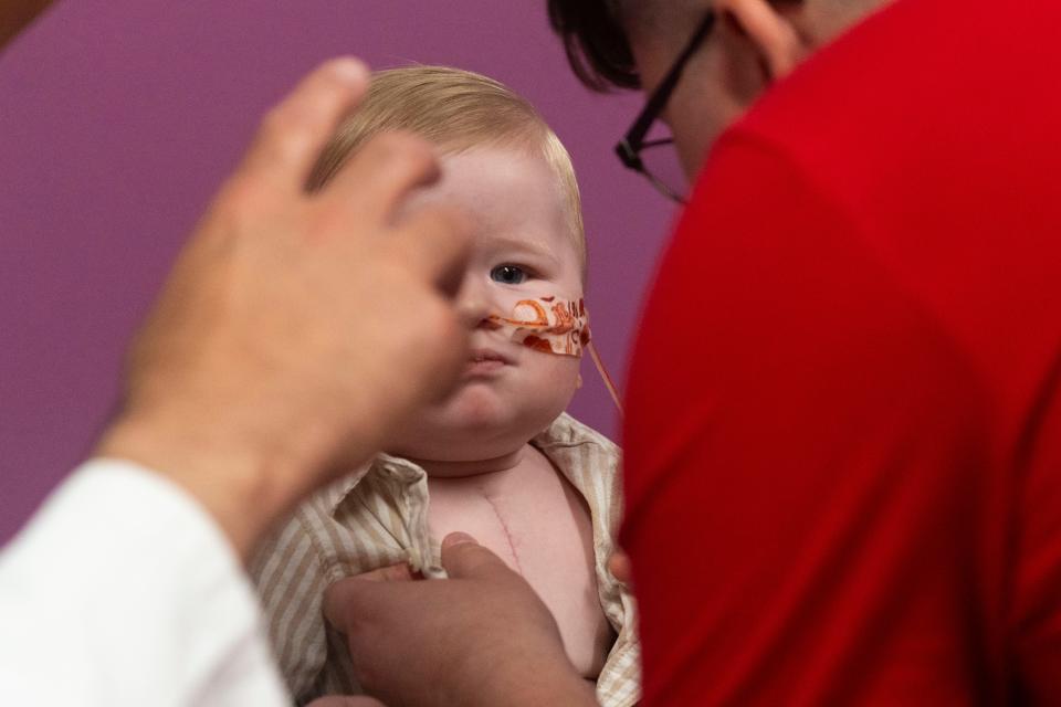 Christian Rodriguez helps son Elias at a checkup this month. Elias is not a fan of having his shirt unbuttoned.