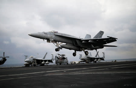 A U.S. F18 fighter jet lands on the deck of U.S. aircraft carrier USS Carl Vinson during an annual joint military exercise called "Foal Eagle" between South Korea and U.S., in the East Sea, South Korea, March 14, 2017. REUTERS/Kim Hong-Ji