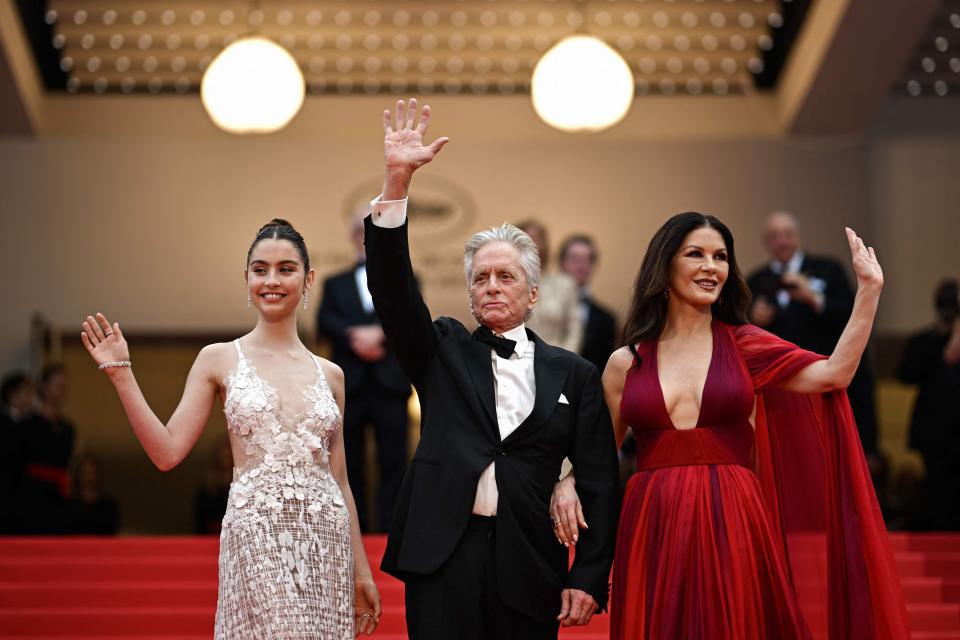 Michael Douglas waves with his daughter and wife at Cannes.