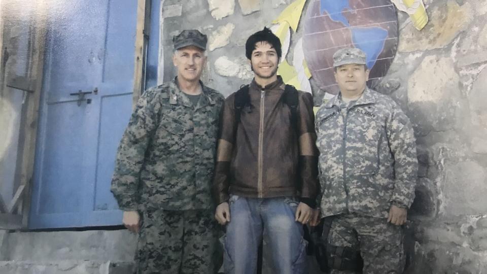Satary, around 23, posing with a Marine colonel, left, and an Army general , right, at a Marine outpost in Kunar province, circa 2007. At the time, Satary interpreted for American units conducting missions throughout the province. (Courtesy Hasib Satary)