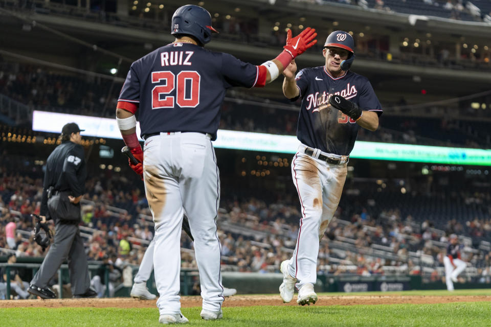 Washington Nationals' Jacob Young, right, celebrates with Keibert Ruiz after scoring against the Chicago White Sox during the sixth inning of a baseball game Tuesday, Sept. 19, 2023, in Washington. (AP Photo/Stephanie Scarbrough)