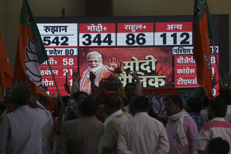 Bharatiya Janata Party (BJP) workers celebrate at BJP headquarters in, Lucknow, India, Thursday, May 23, 2019. Indian Prime Minister Narendra Modi and his party were off to an early lead as vote counting began Thursday following the conclusion of the country's 6-week-long general election, sending the stock market soaring in anticipation of another five-year term for the Hindu nationalist leader.(AP Photo/Rajesh Kumar Singh)