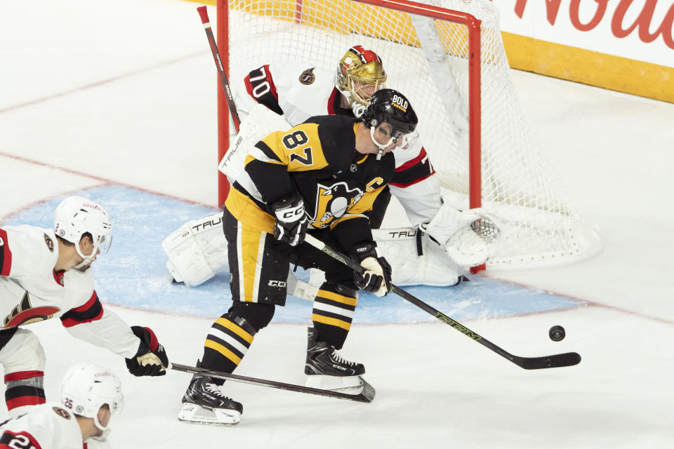 Pittsburgh Penguins' Sidney Crosby is stopped by Ottawa Senators goaltender Joonas Korpisalo during the third period of an NHL hockey game action in Halifax, Nova Scotia, Monday, Oct. 2, 2023. (Darren Calabrese/The Canadian Press via AP)