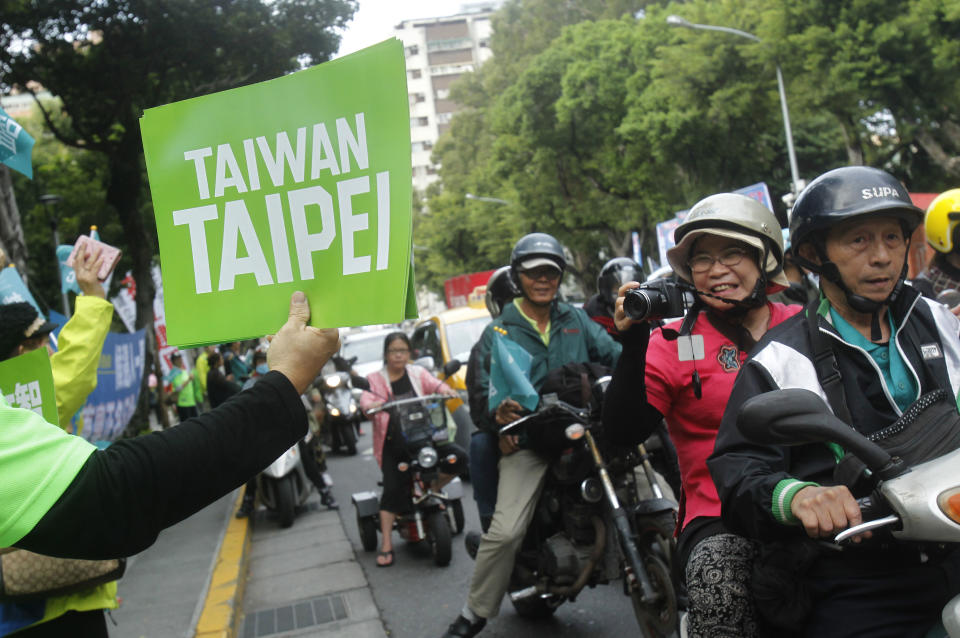 In this photo taken Saturday, Nov. 3, 2018, supporters cheer as they show a banner with the slogan "Taiwan Taipei" during a rally for a referendum asking if national teams, including for the Olympics, should go by the name "Taiwan Taipei" instead of "Chinese Taipei" in Taipei, Taiwan. Taiwan will vote on a referendum this month asking if the self-ruled island should compete as “Taiwan” instead of the present “Chinese Taipei.” This would include the 2020 Olympics in Tokyo. The controversial referendum has angered China, which sees Taiwan as a breakaway province. (AP Photo/Chiang Ying-ying)